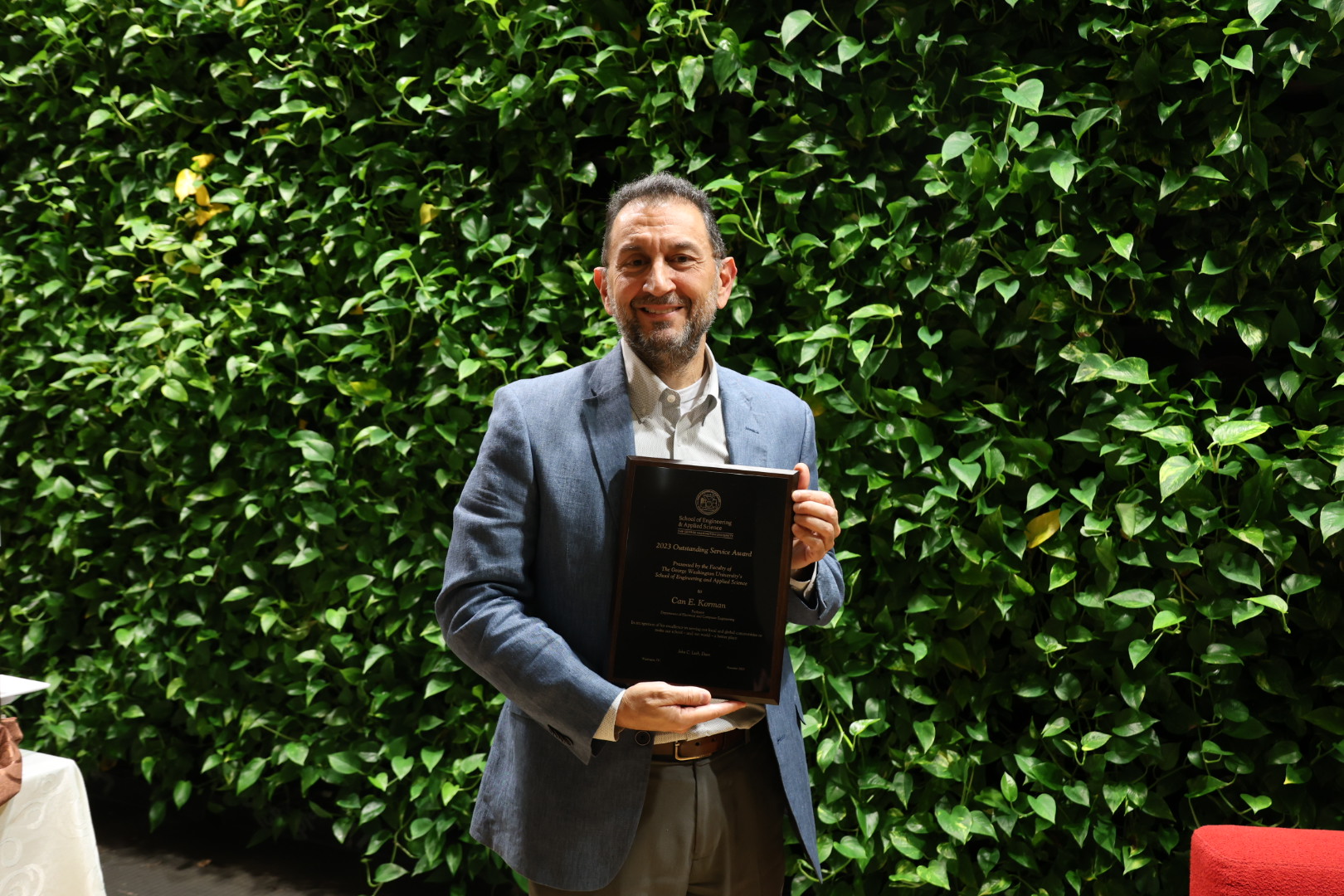 Professor Korman holding his award plaque